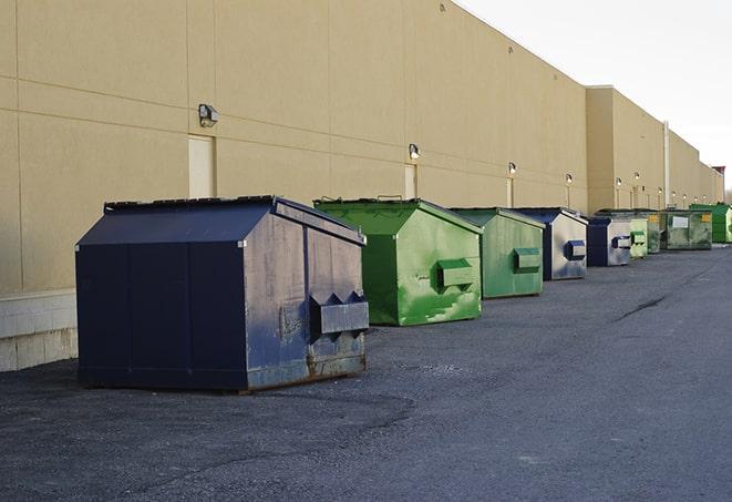 a construction worker empties a wheelbarrow of waste into the dumpster in Broadview Heights, OH